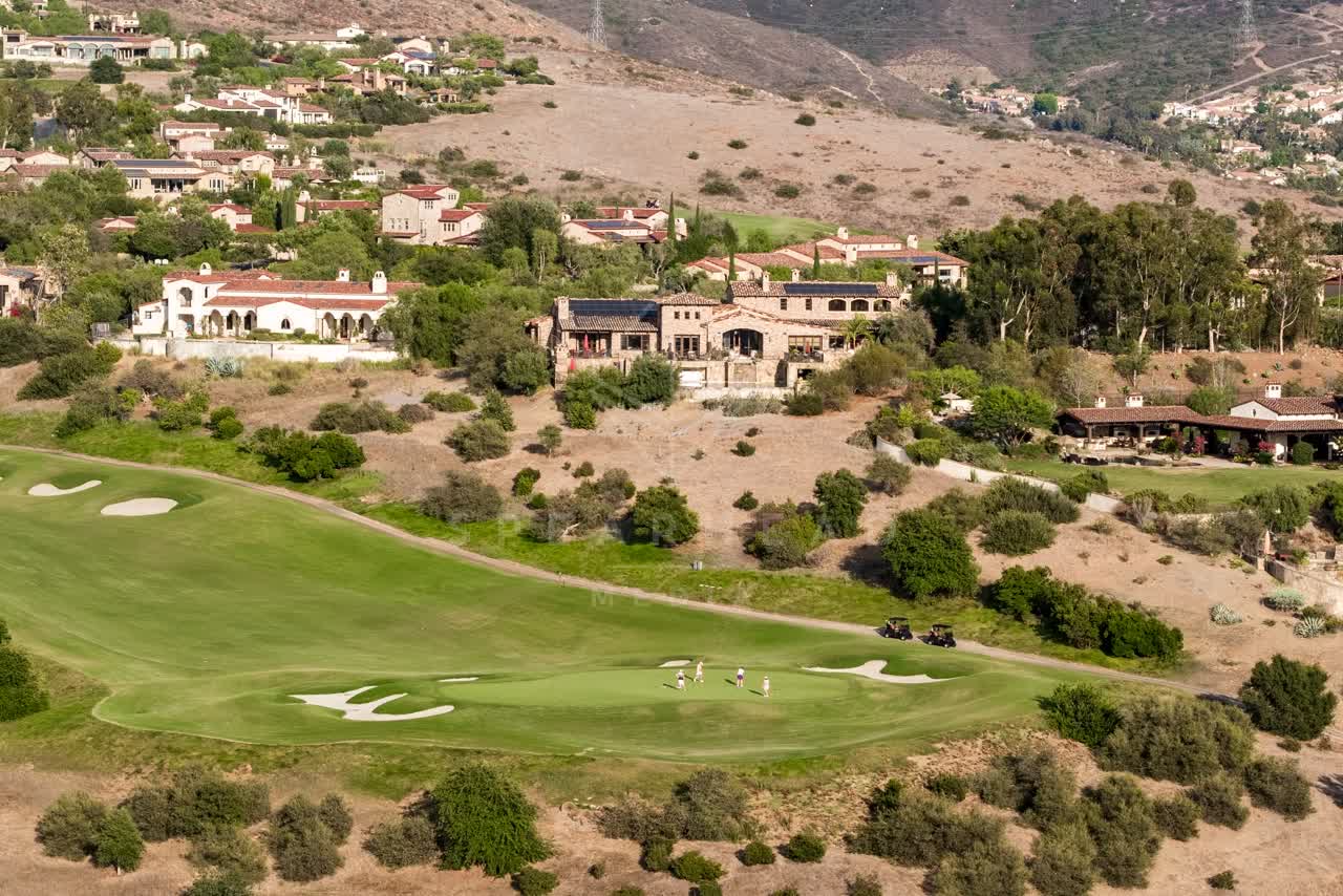 Aerial view of the country inland, homes and the buildings in Santaluz, with people walking.