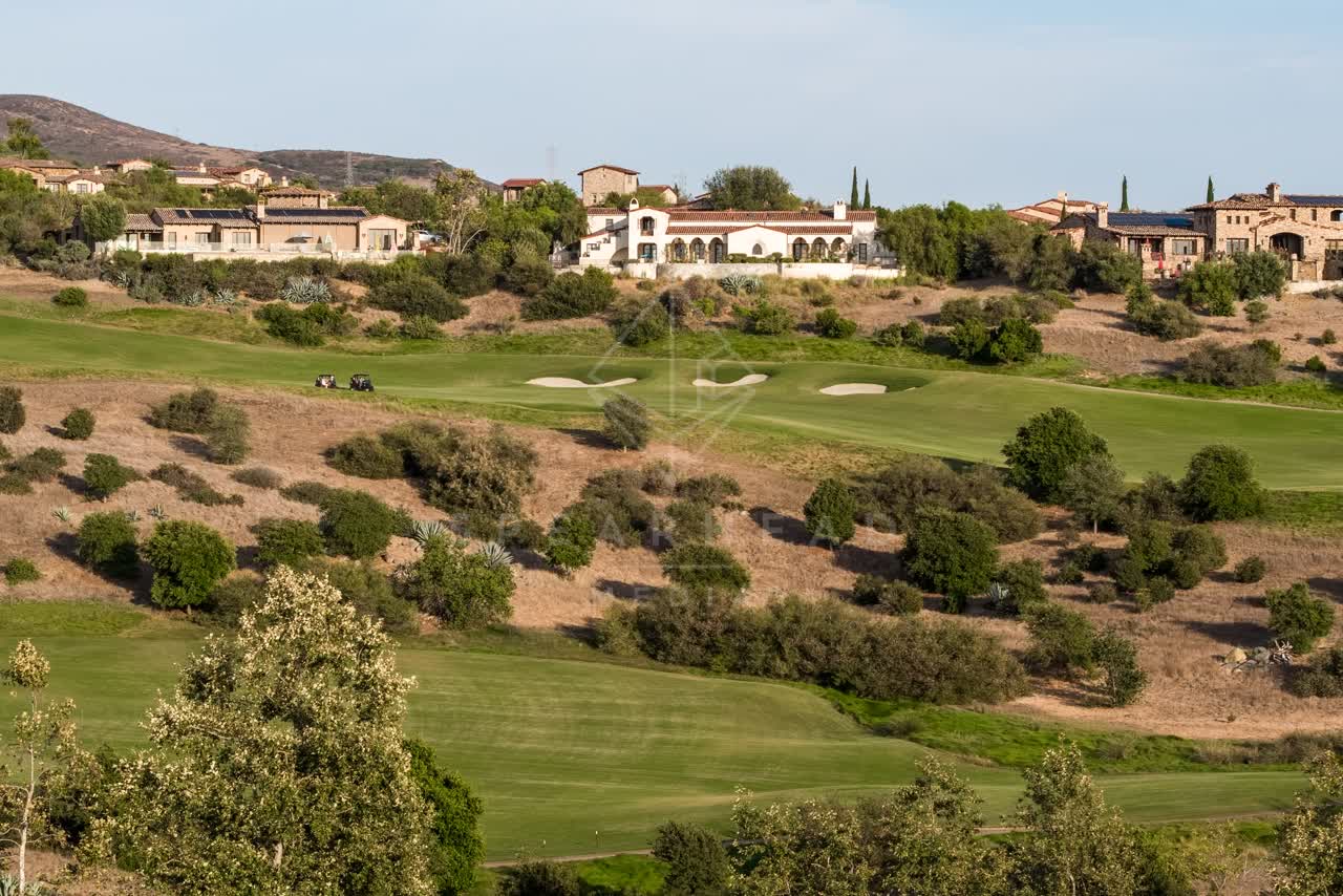 Low aerial view of the country inland, homes and the buildings in Santaluz.