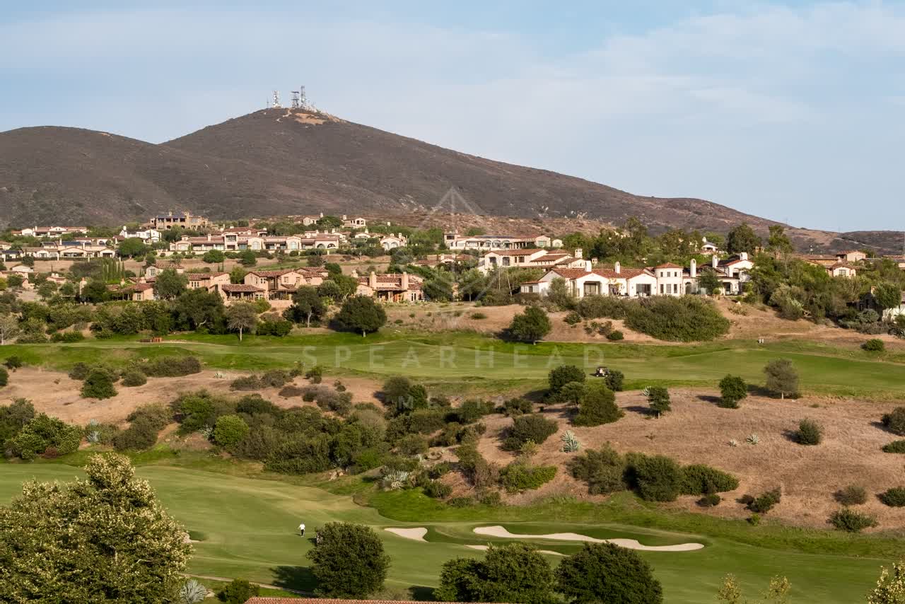 Low aerial view of the country inland, homes and the buildings in Santaluz.
