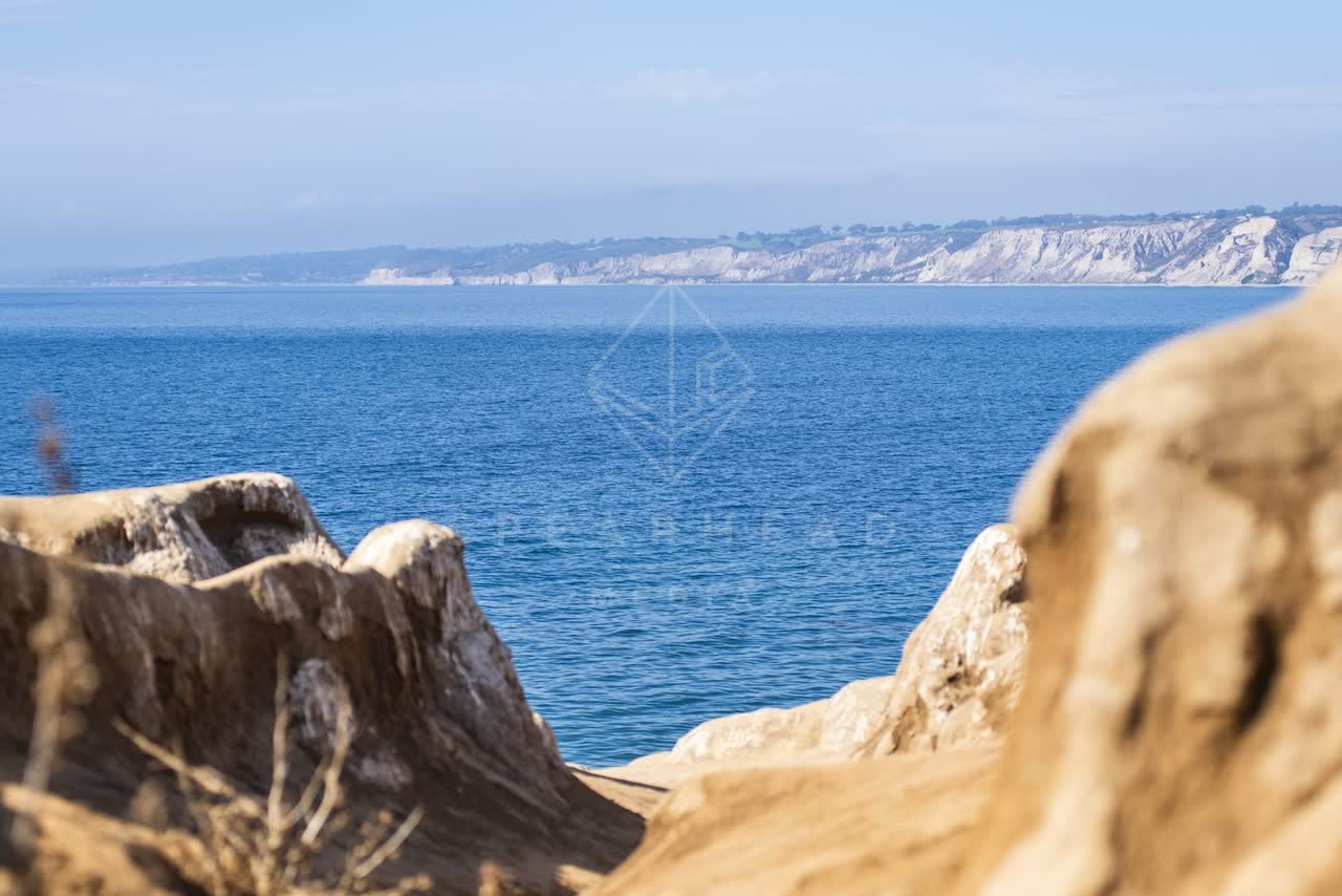 Elevated view of the cliffs, the ocean and open country at La Jolla Cove.