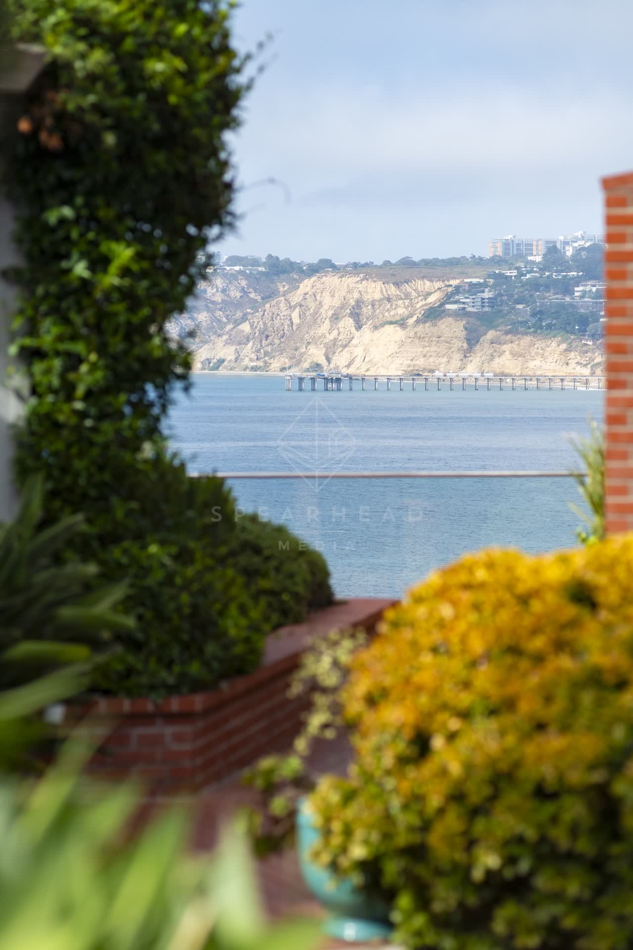 Elevated view of a residential street, the pier and the ocean at La Jolla Cove.