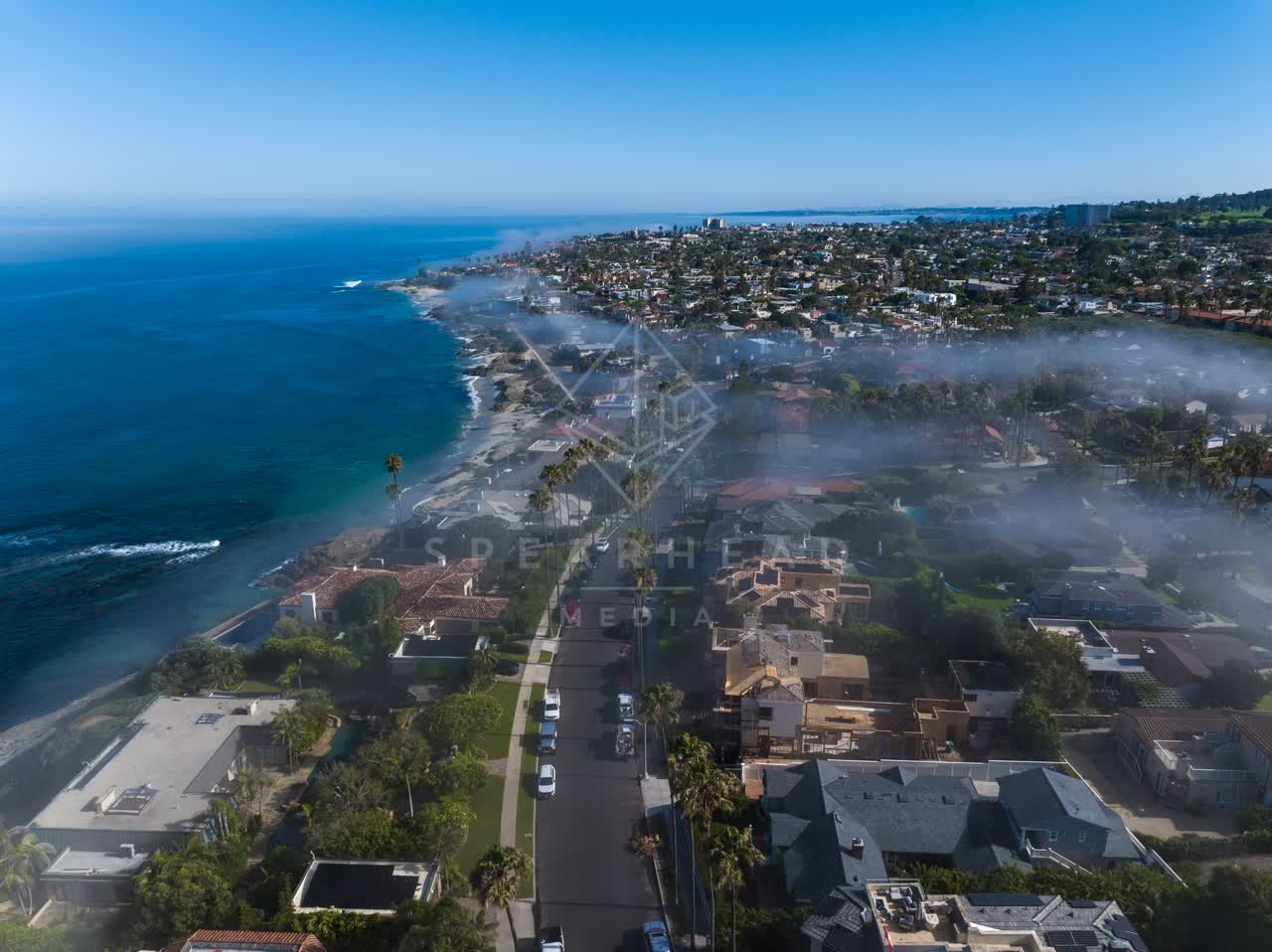 Aerial view of a residential street, palm trees and the ocean at Lower Hermosa.