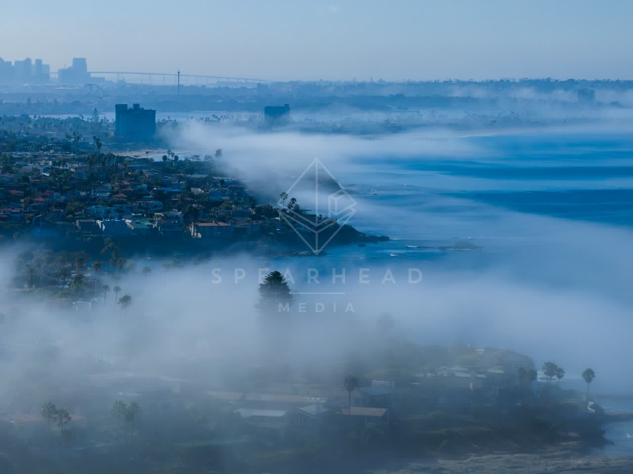 Aerial view of a residential street, the bridge and the skyline at Lower Hermosa.
