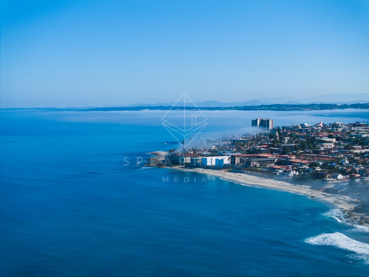 Aerial view of the beach, the surf and the ocean at Windansea.