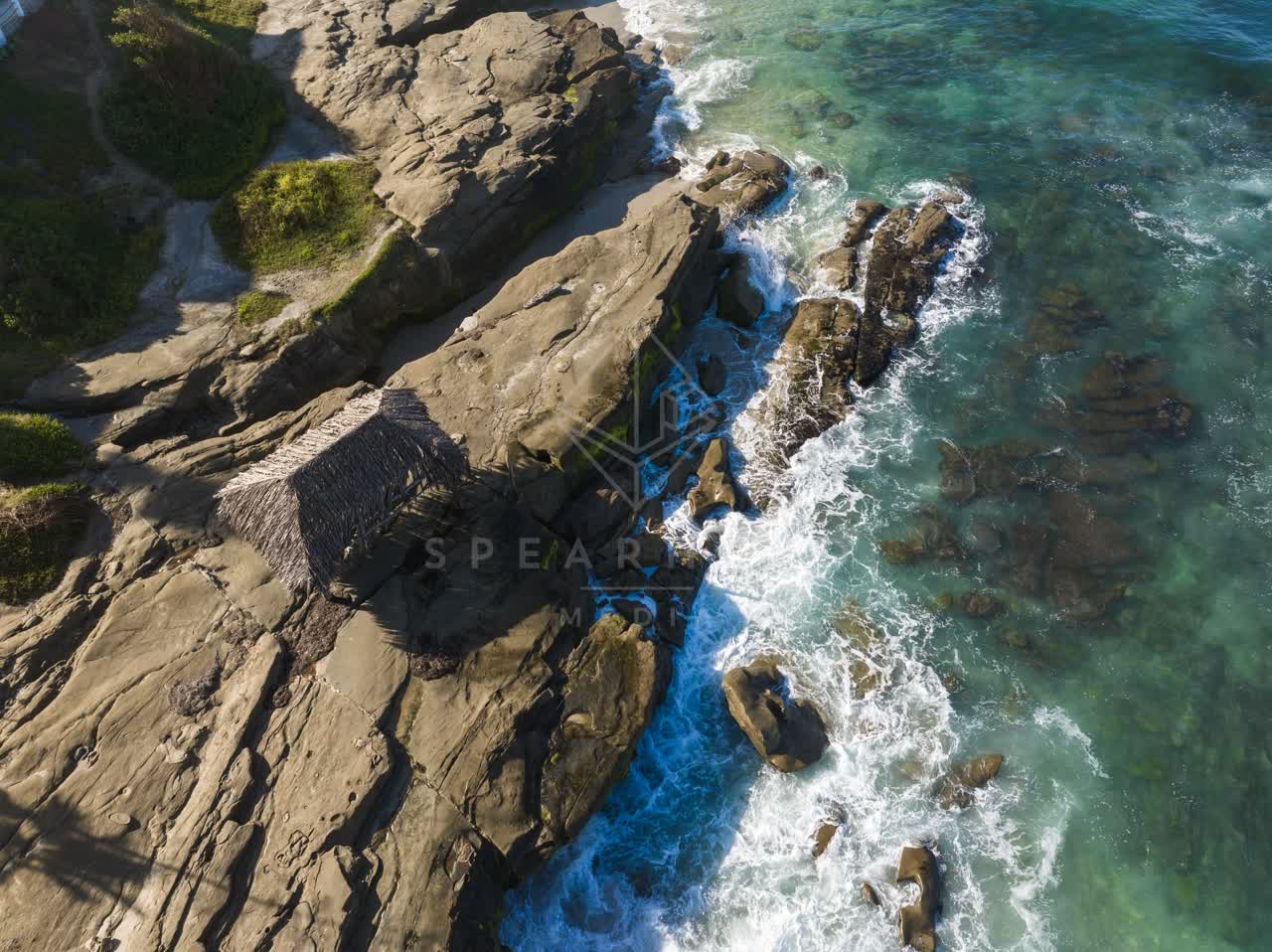 Aerial view of the cliffs, the surf and the ocean at Windansea.