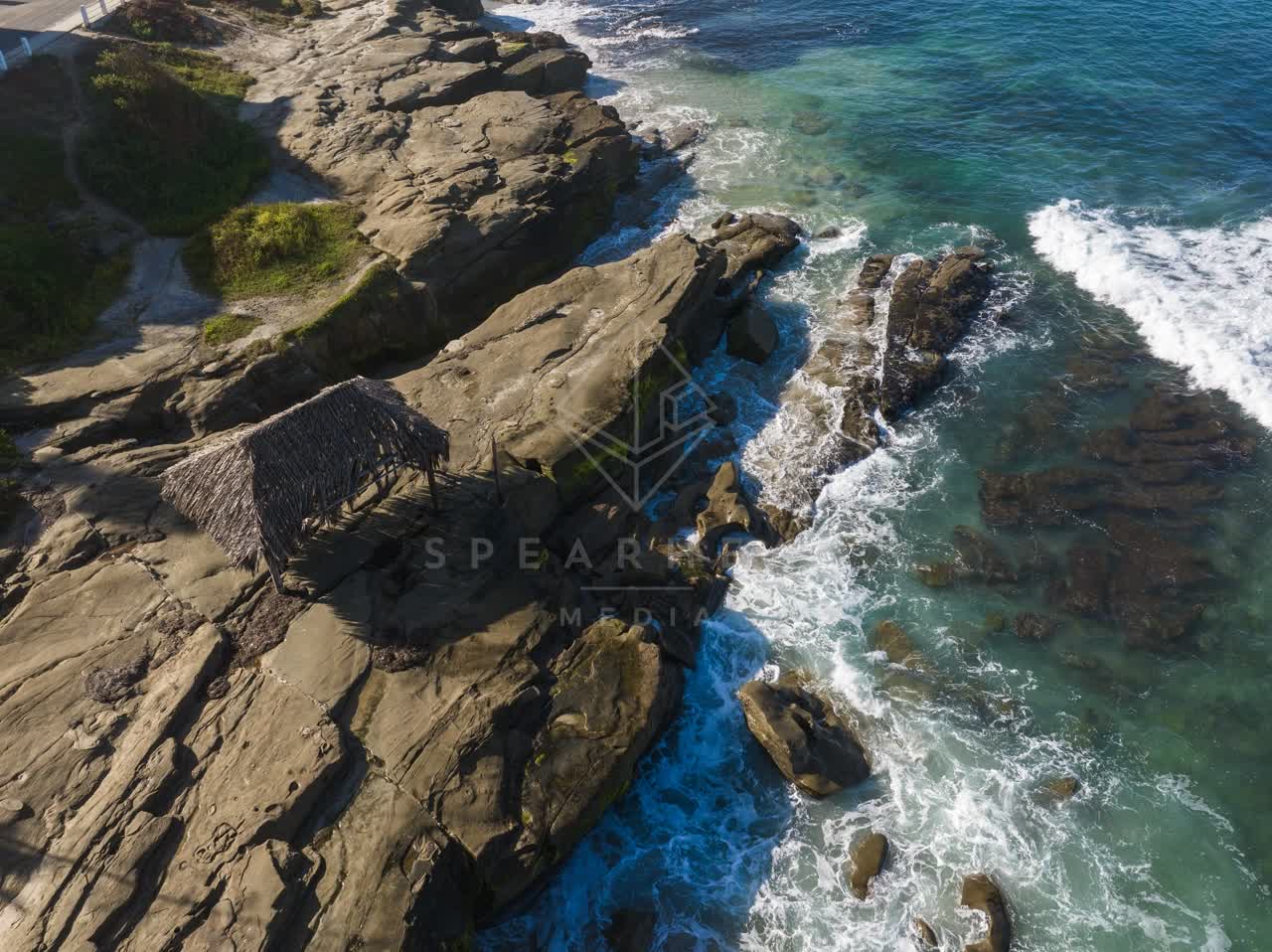 Aerial view of the cliffs, the surf and the ocean at Windansea.