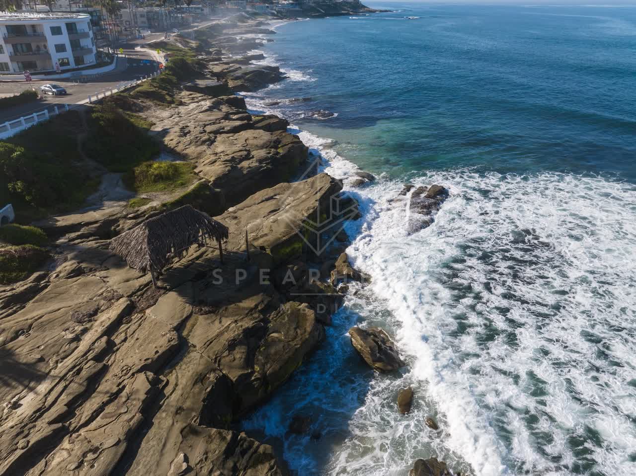 Aerial view of the cliffs, the surf and the ocean at Windansea.