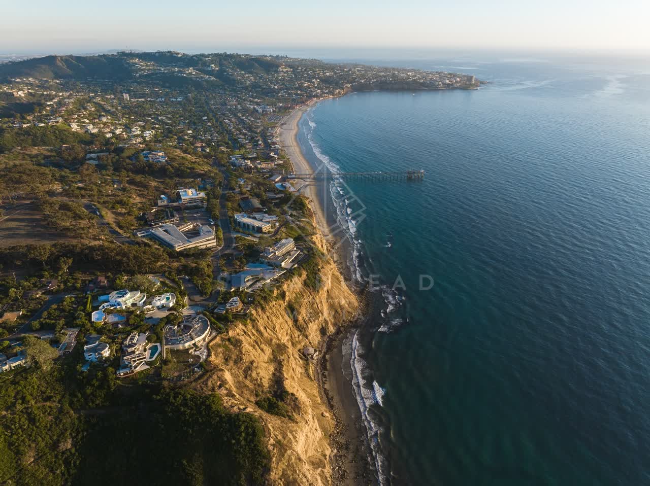 Aerial view of the cliffs, the pier and the ocean at La Jolla Shores.