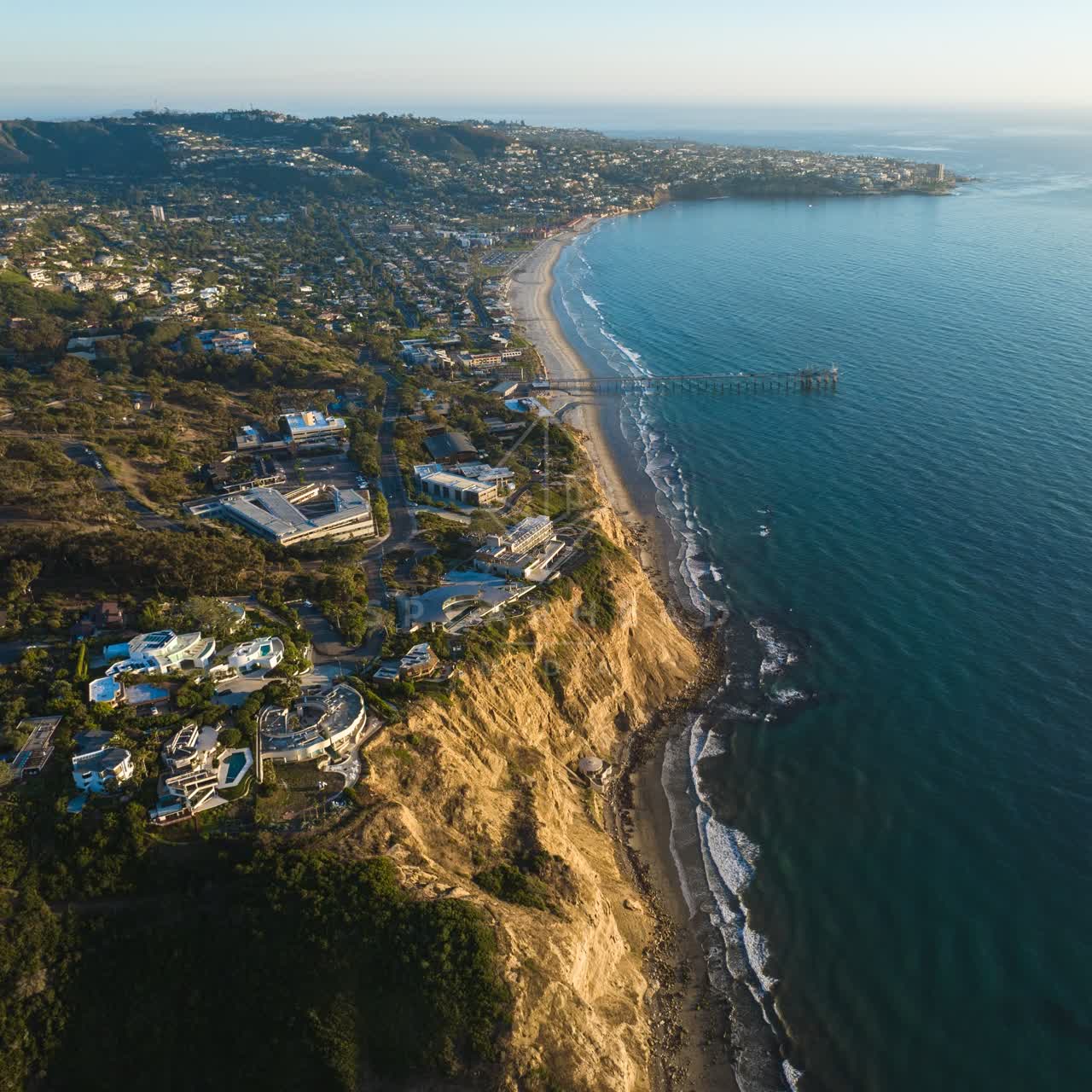Aerial view of the cliffs, the pier and boats at La Jolla Shores.