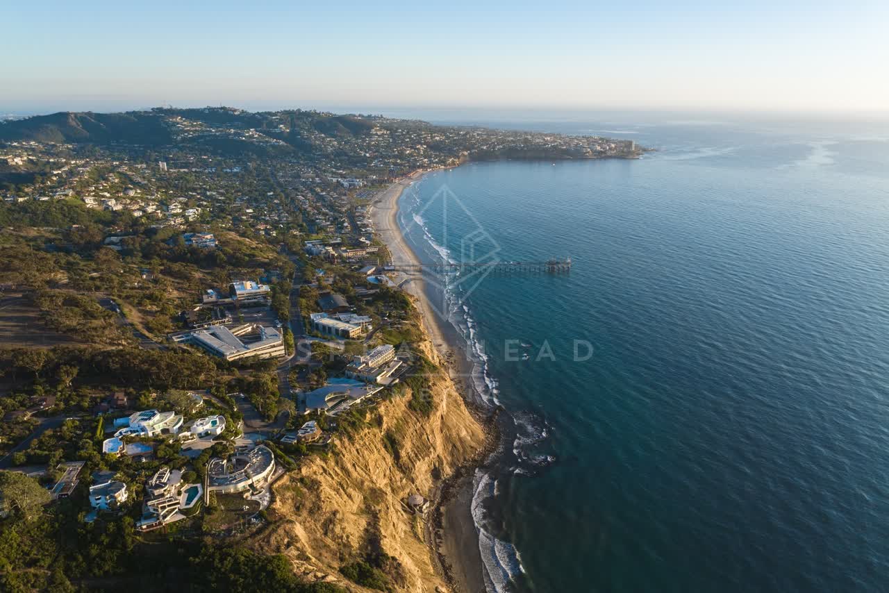 Aerial view of the cliffs, the pier and the ocean at La Jolla Shores.