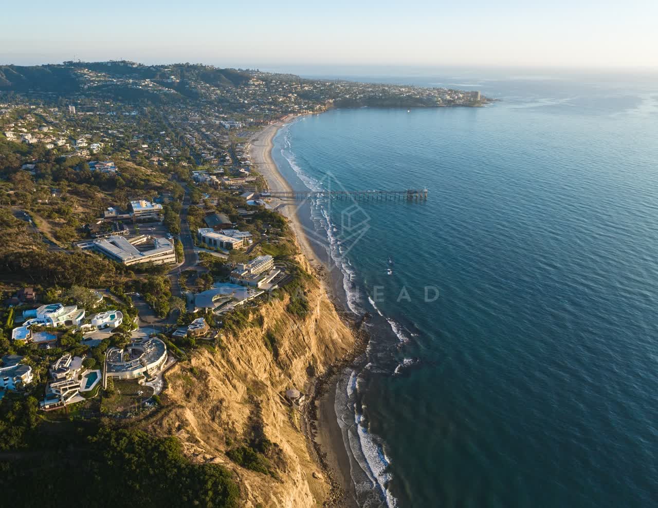 Aerial view of the cliffs, the pier and the ocean at La Jolla Shores.