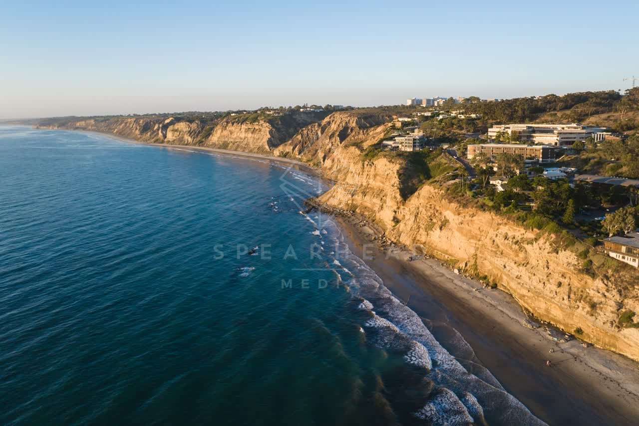 Aerial view of the cliffs, the surf and the ocean at Black’s Beach.