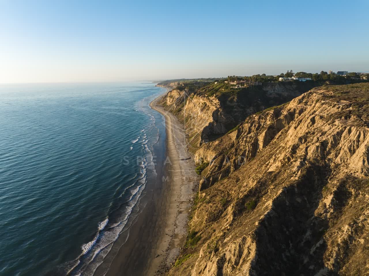 Aerial view of the cliffs, the ocean and homes at Black’s Beach.