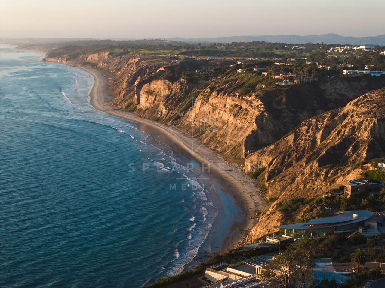 Aerial view of the cliffs, the ocean and homes at Black’s Beach.