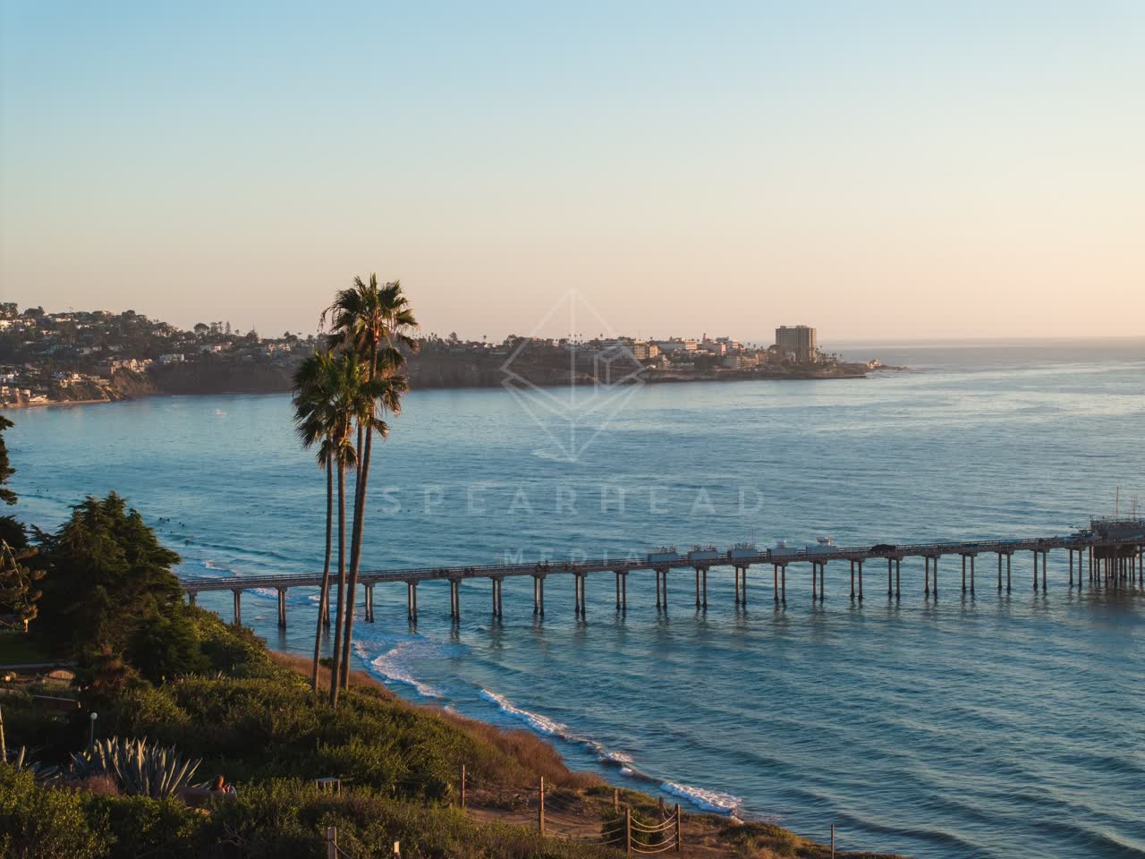 Elevated view of the cliffs, the surf and the pier at La Jolla Shores.
