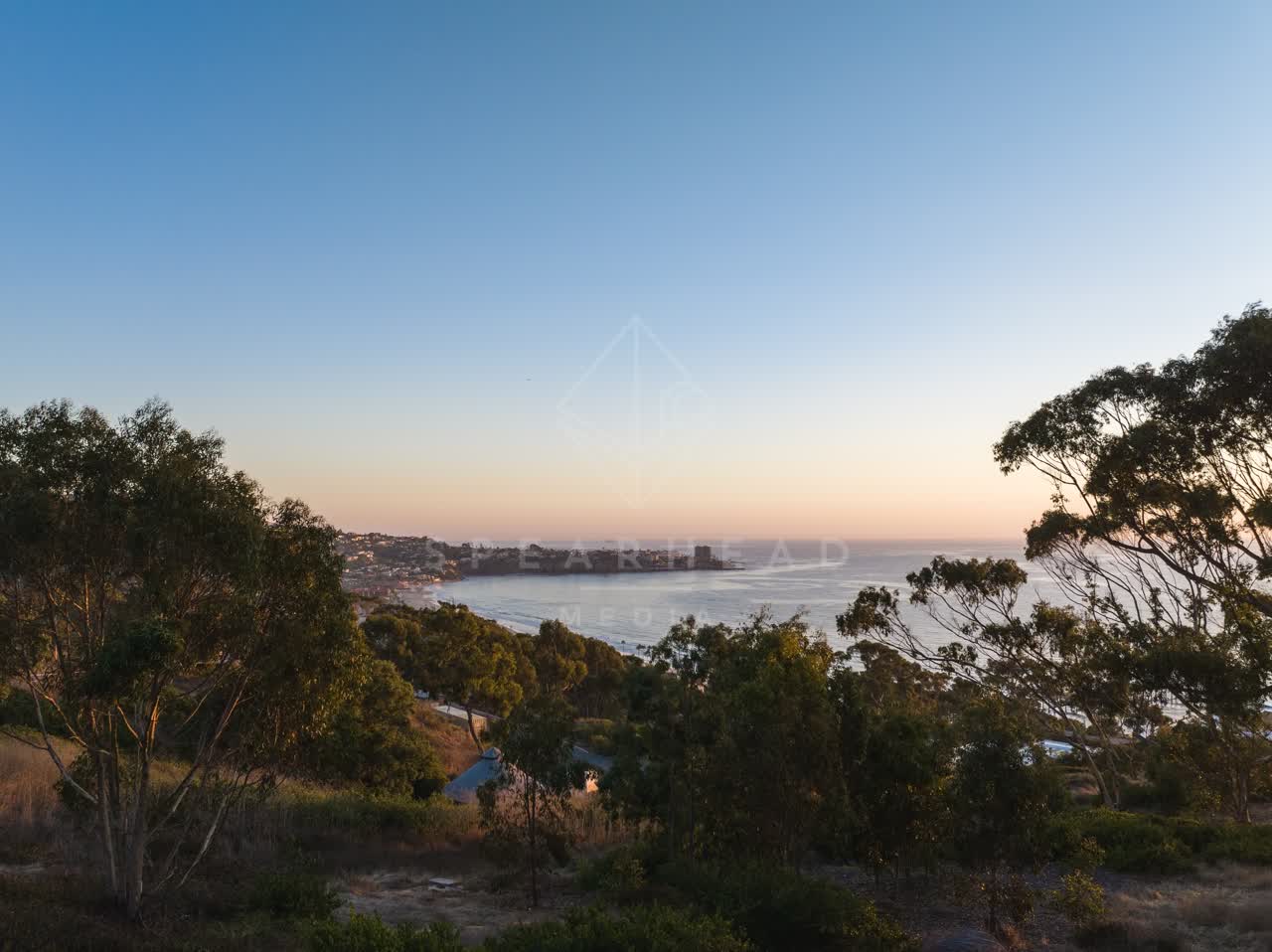 Elevated view of the cliffs, the pier and the ocean at La Jolla Shores.