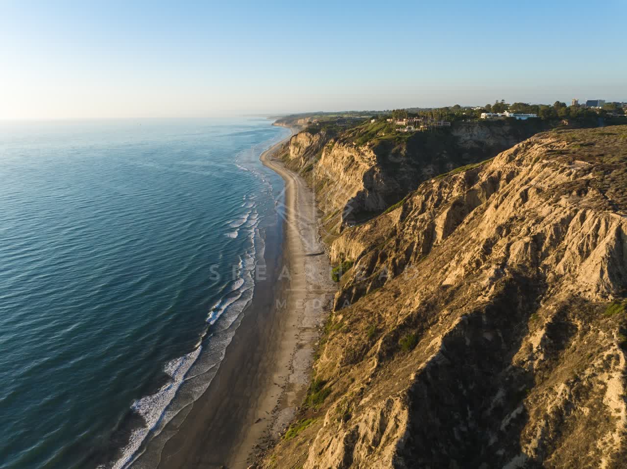 Aerial view of the cliffs, the ocean and homes at Black’s Beach.
