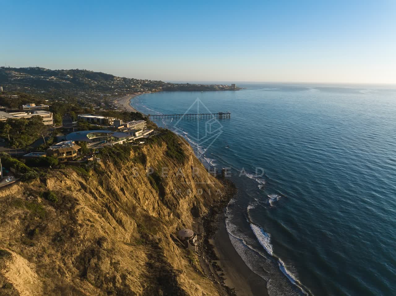 Aerial view of the cliffs, the pier and the ocean at La Jolla Shores.