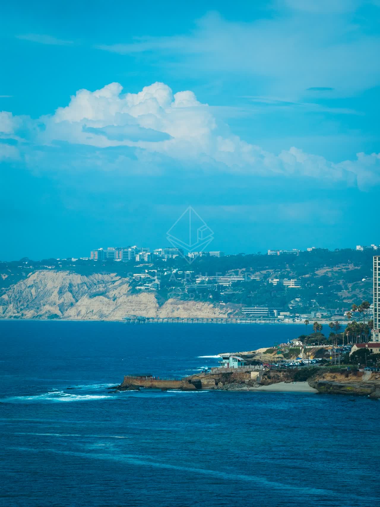 Aerial view of the cliffs, the pier and the ocean at La Jolla Cove.