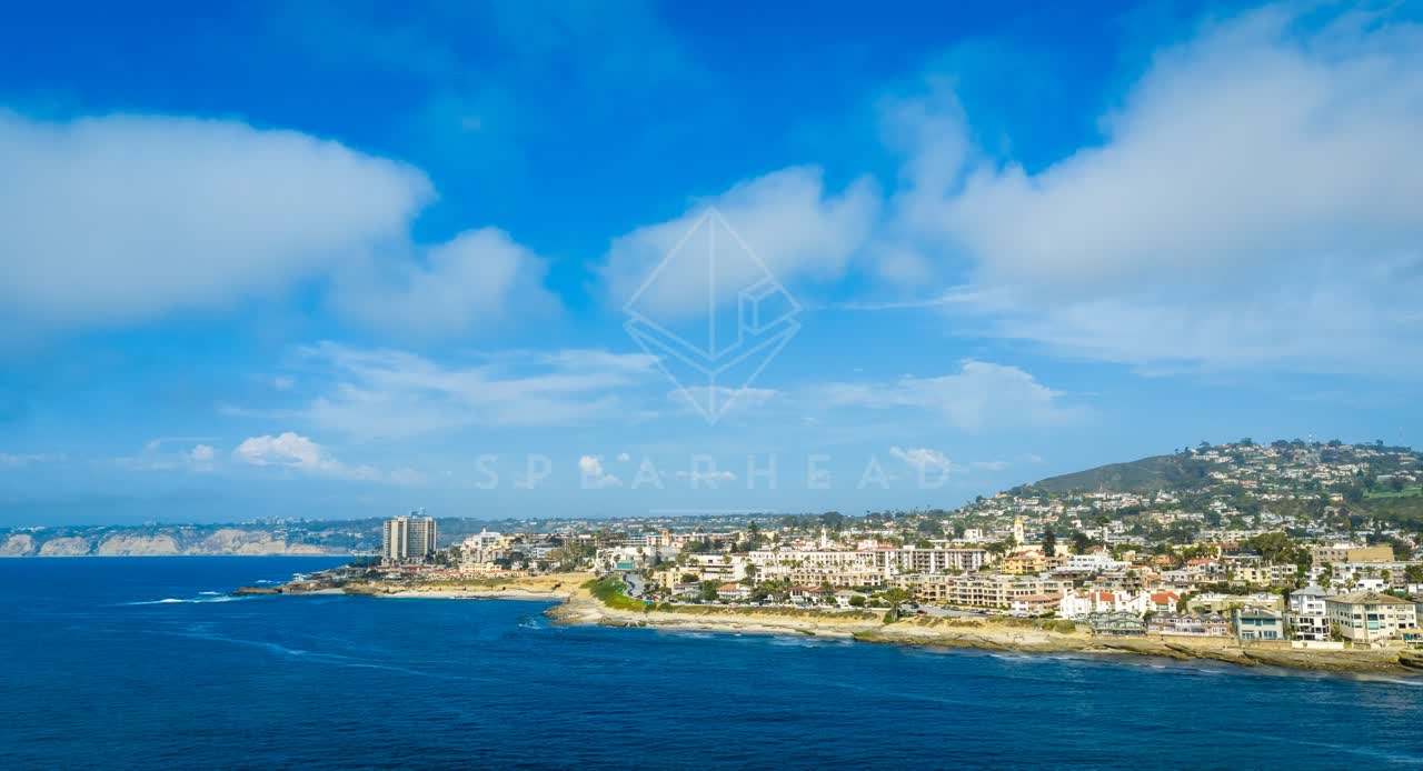 Aerial view of the beach, the ocean and homes at La Jolla Cove.