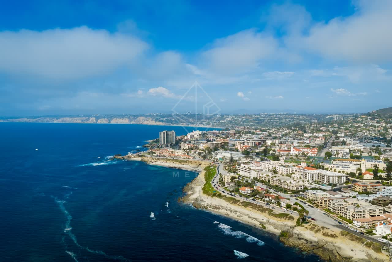 Aerial view of the cliffs, the surf and the ocean at La Jolla Cove.