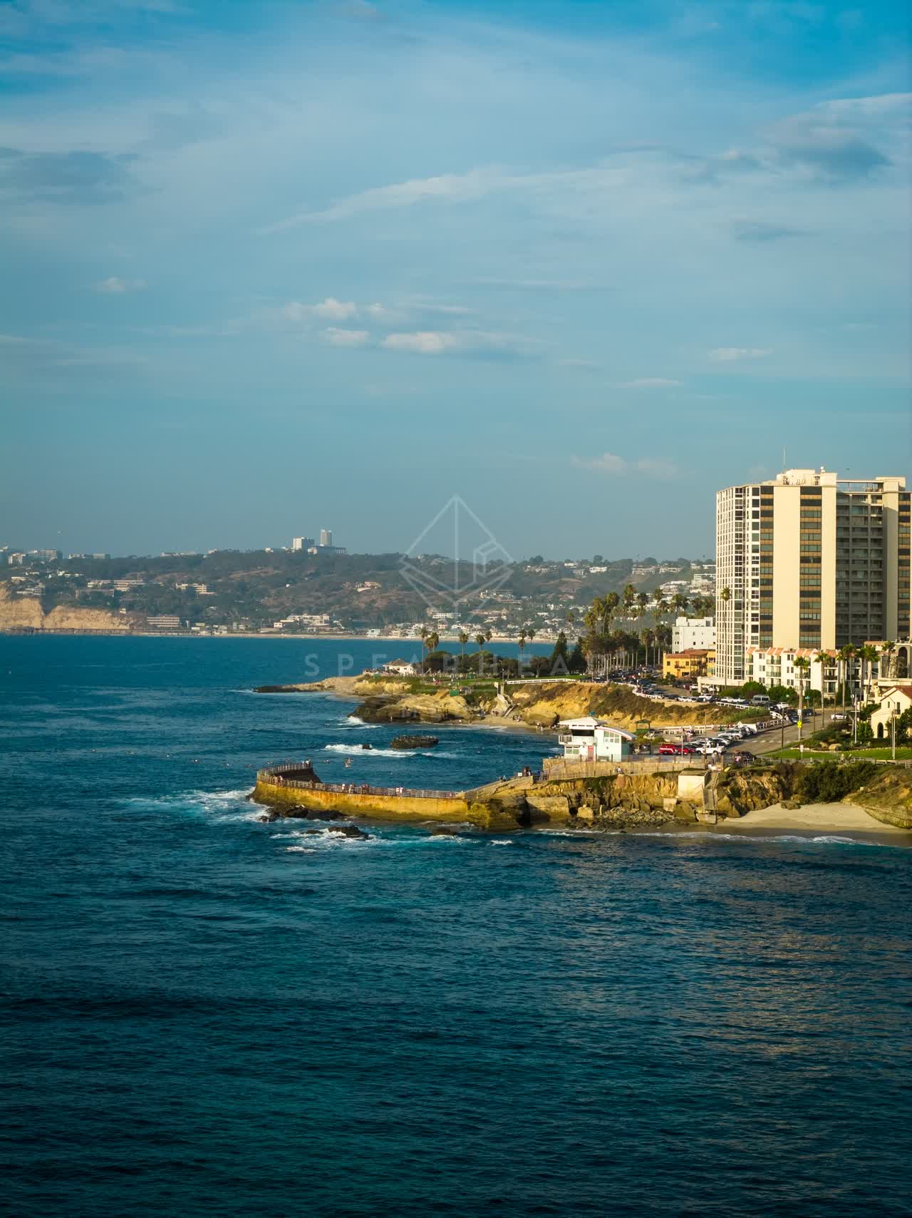 Aerial view of the cliffs, the ocean and homes at Village of La Jolla.