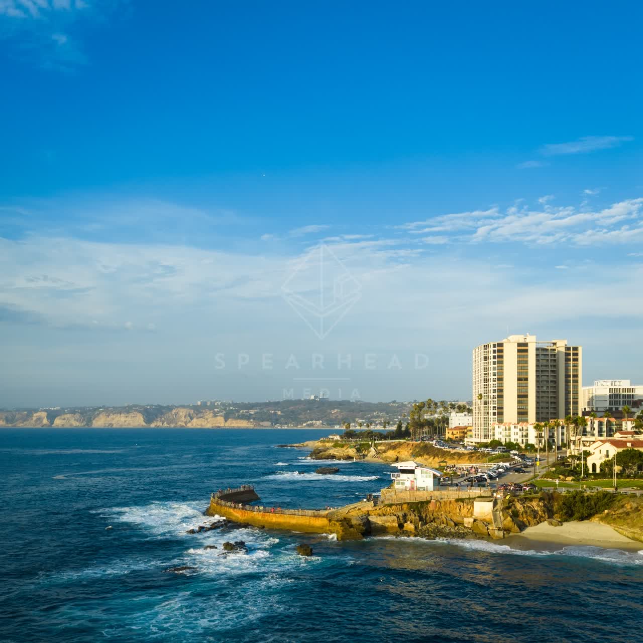 Aerial view of the cliffs, the ocean and homes at Village of La Jolla.