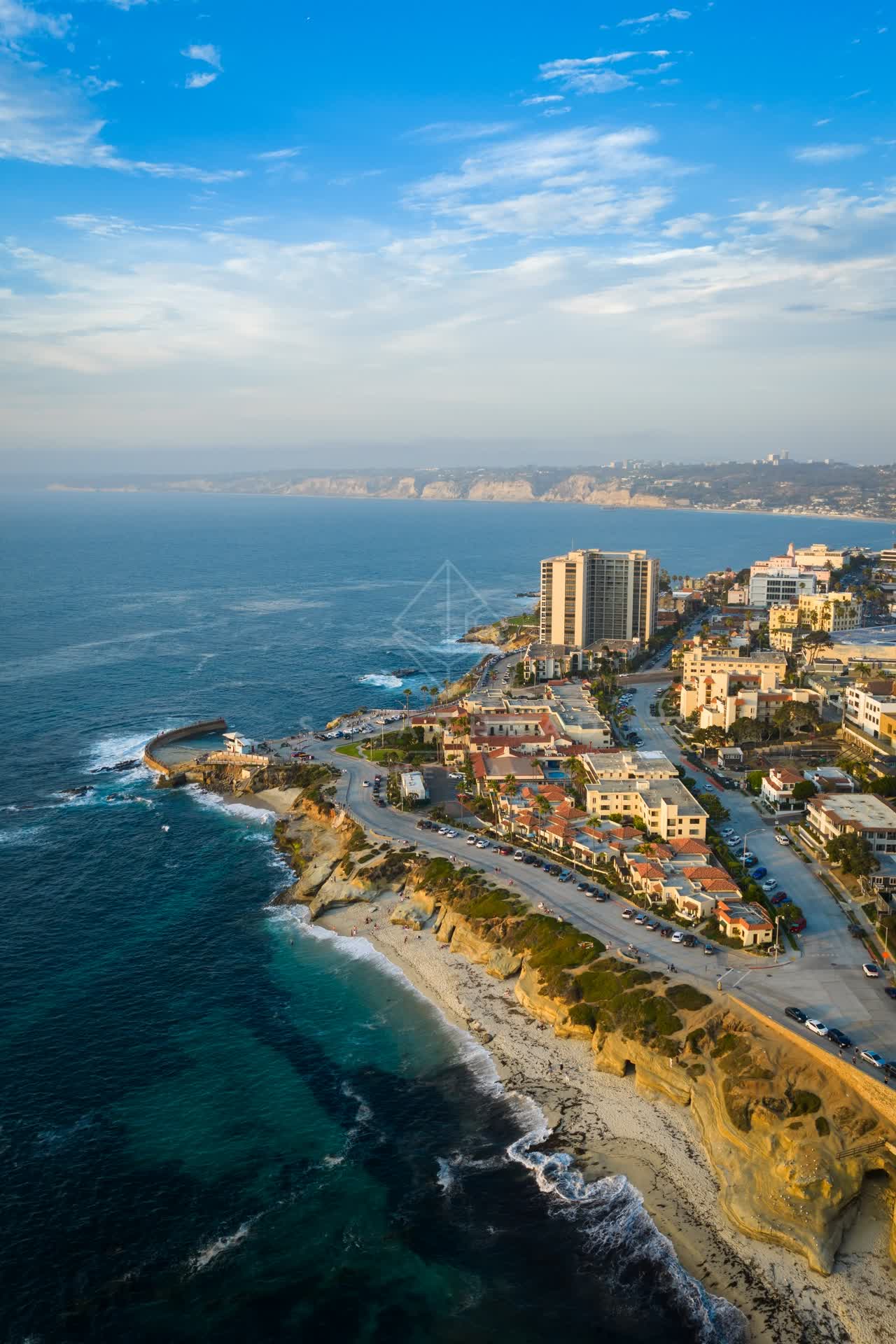 Aerial view of the cliffs, the surf and the ocean at Village of La Jolla.