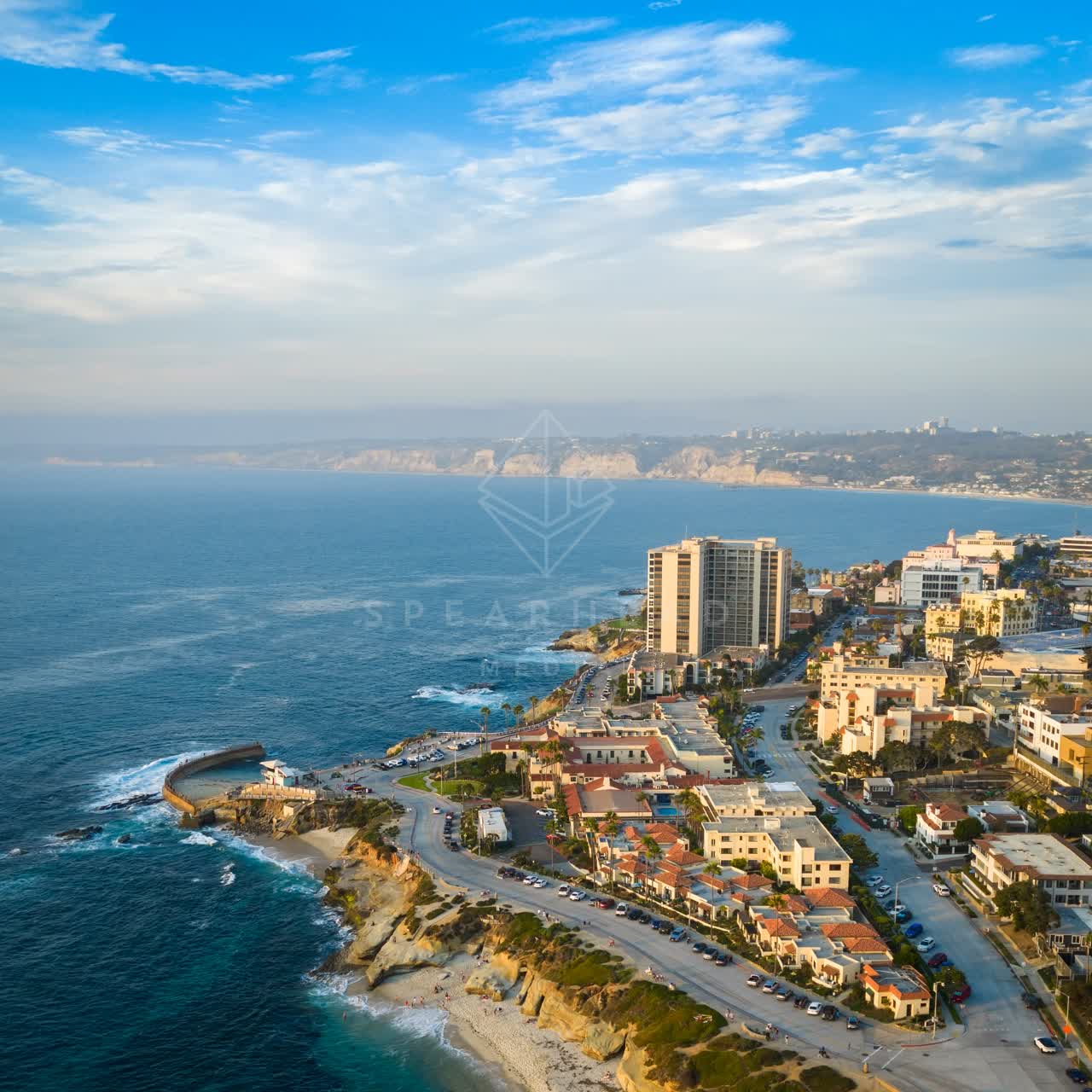 Aerial view of the cliffs, the ocean and homes at Village of La Jolla.