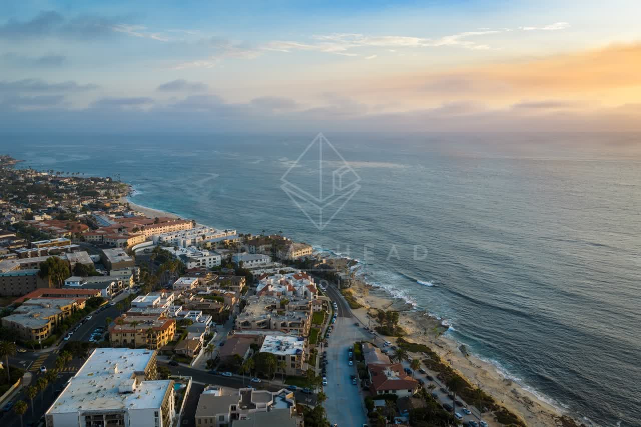 Aerial view of a residential street, the ocean and homes at Village of La Jolla.