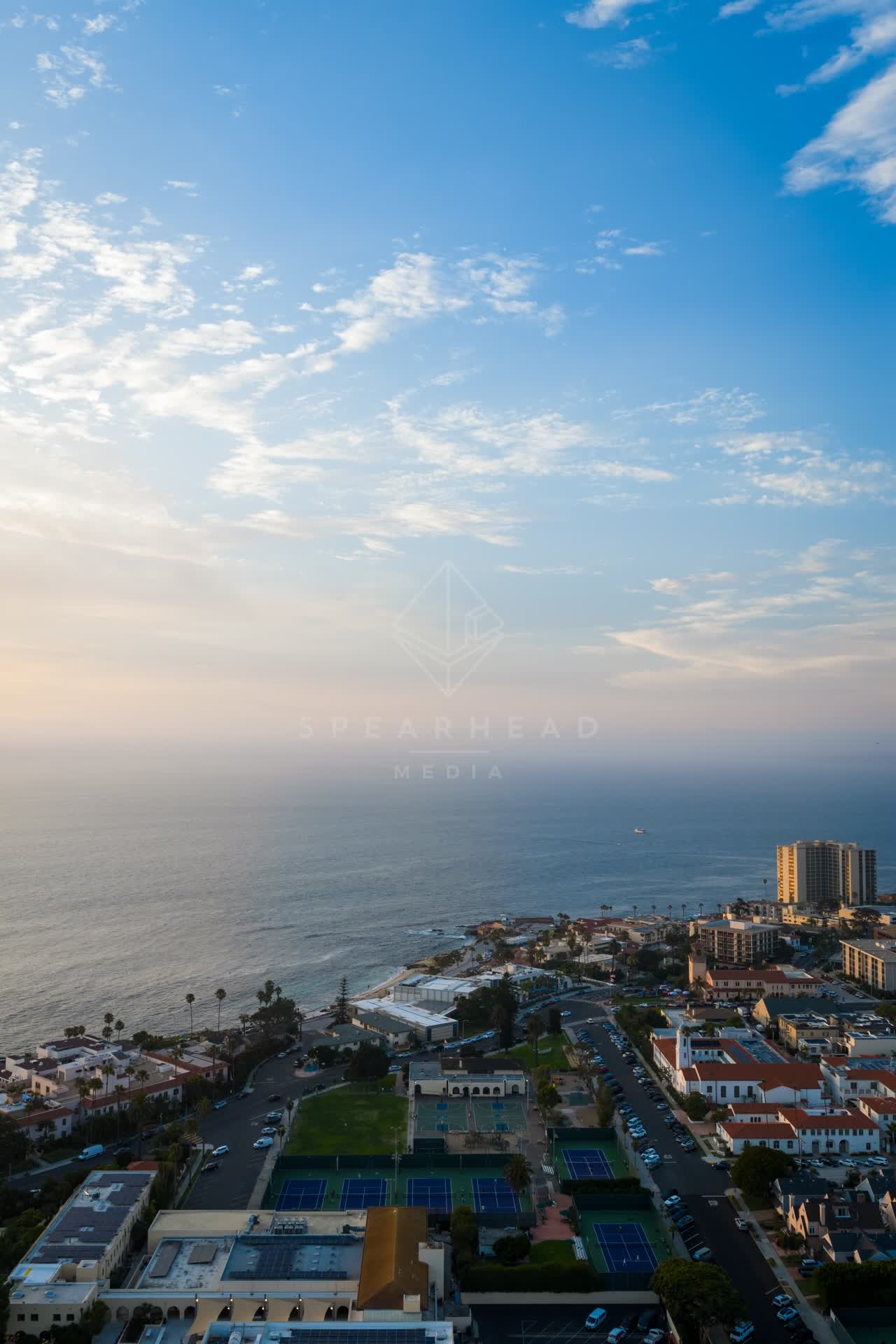 Aerial view of the cliffs, palm trees and the ocean at La Jolla Cove.