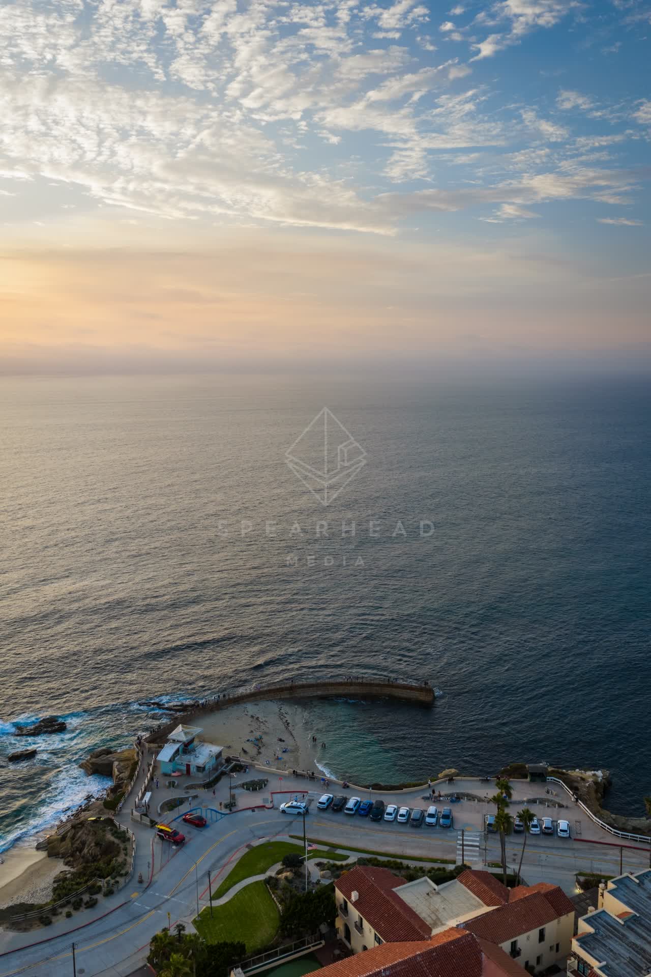 Aerial view of the beach, the ocean and the cliffs at Village of La Jolla.