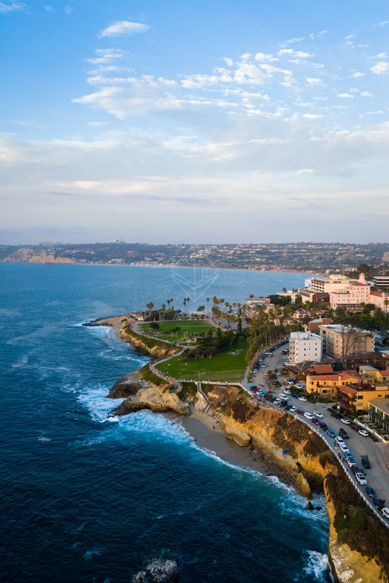 Aerial view of the cliffs, palm trees and the ocean at Village of La Jolla.