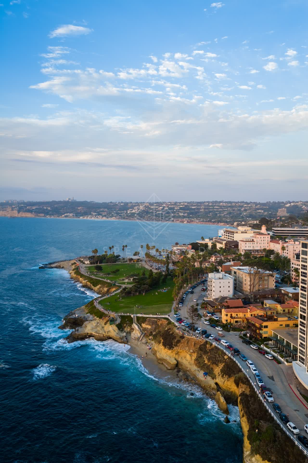 Aerial view of the cliffs, palm trees and the ocean at Village of La Jolla.