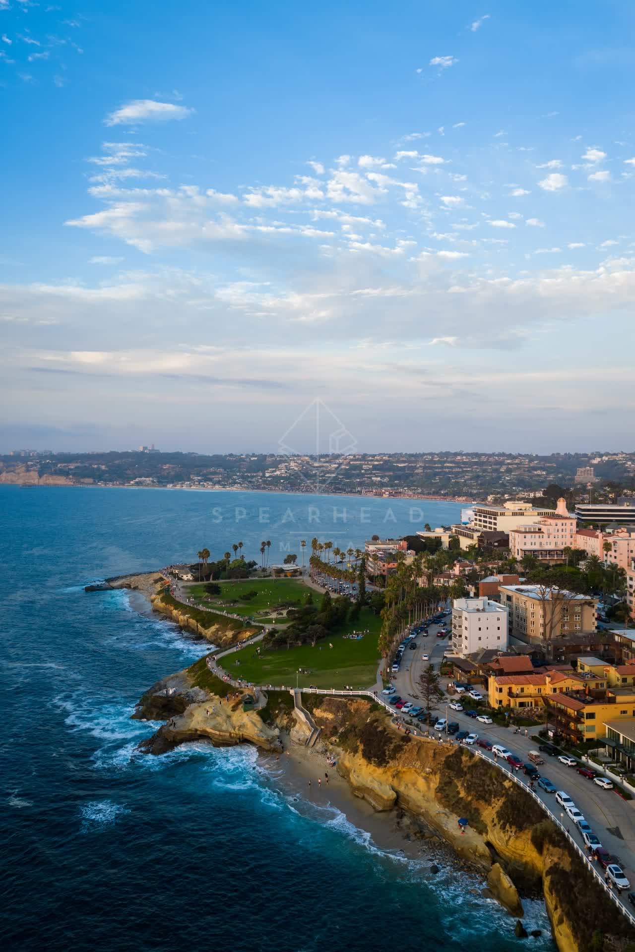 Aerial view of the cliffs, palm trees and the ocean at Village of La Jolla.