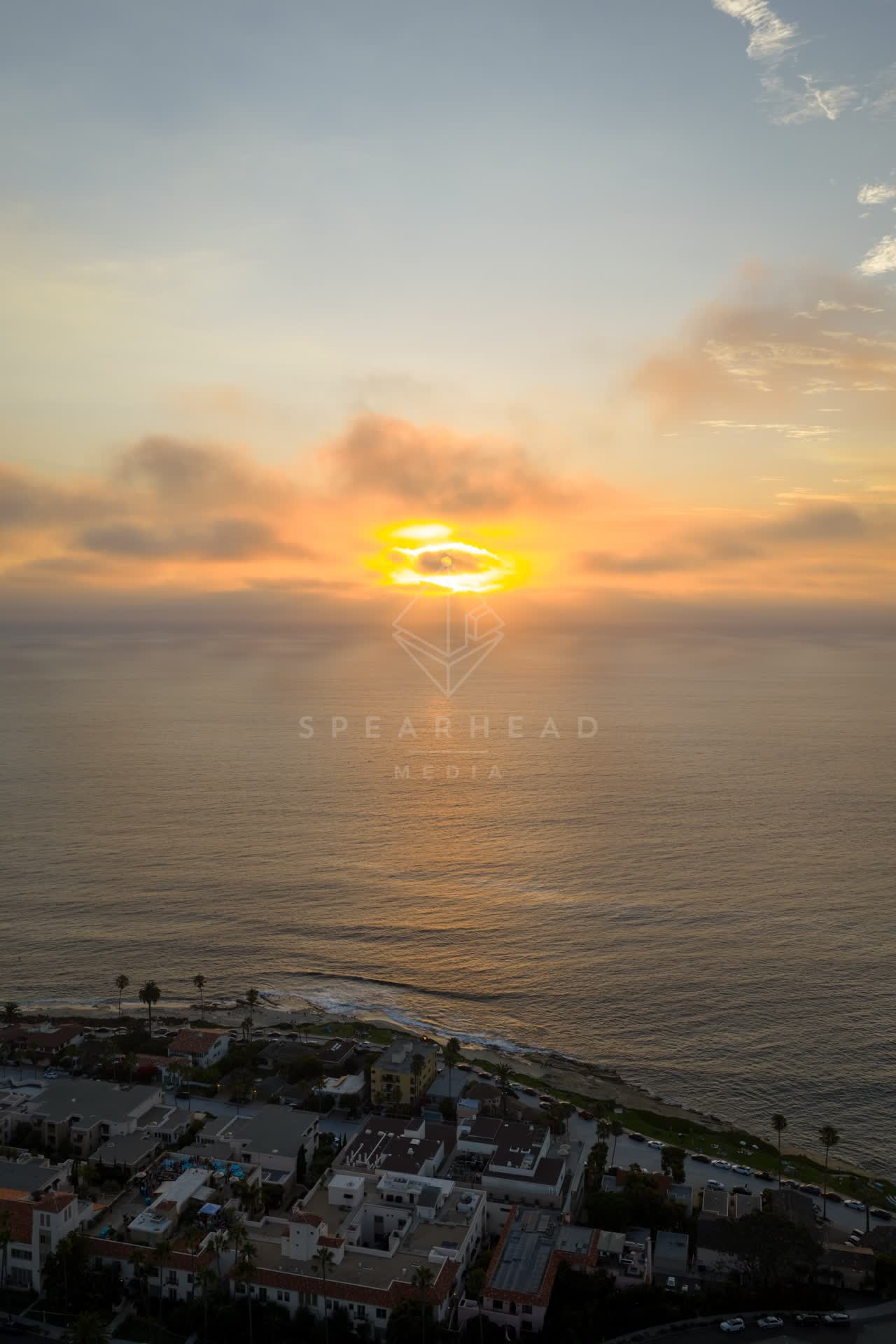 Aerial view of the cliffs, palm trees and the ocean at Village of La Jolla.
