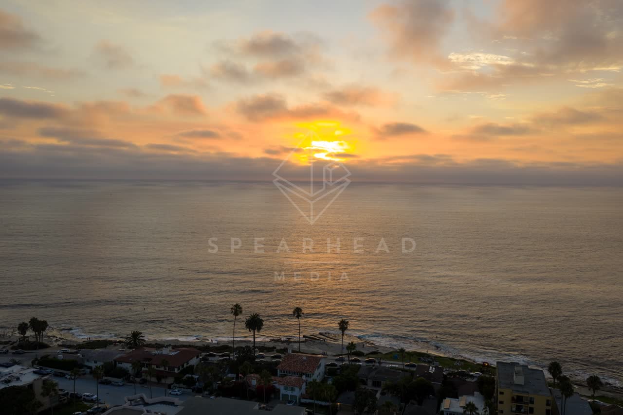 Aerial view of the beach, palm trees and the ocean at Village of La Jolla.