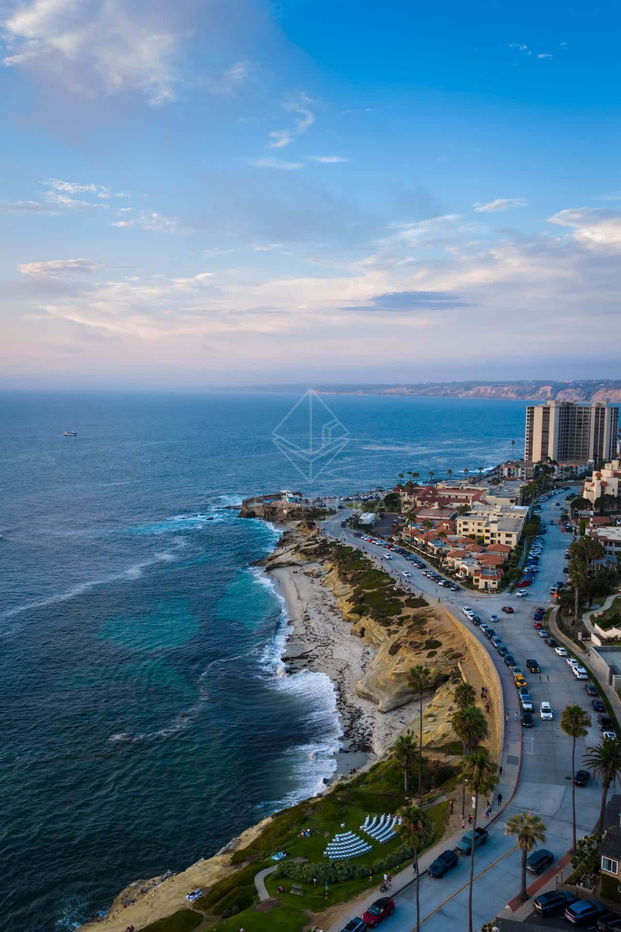 Aerial view of the cliffs, palm trees and the ocean at Village of La Jolla.