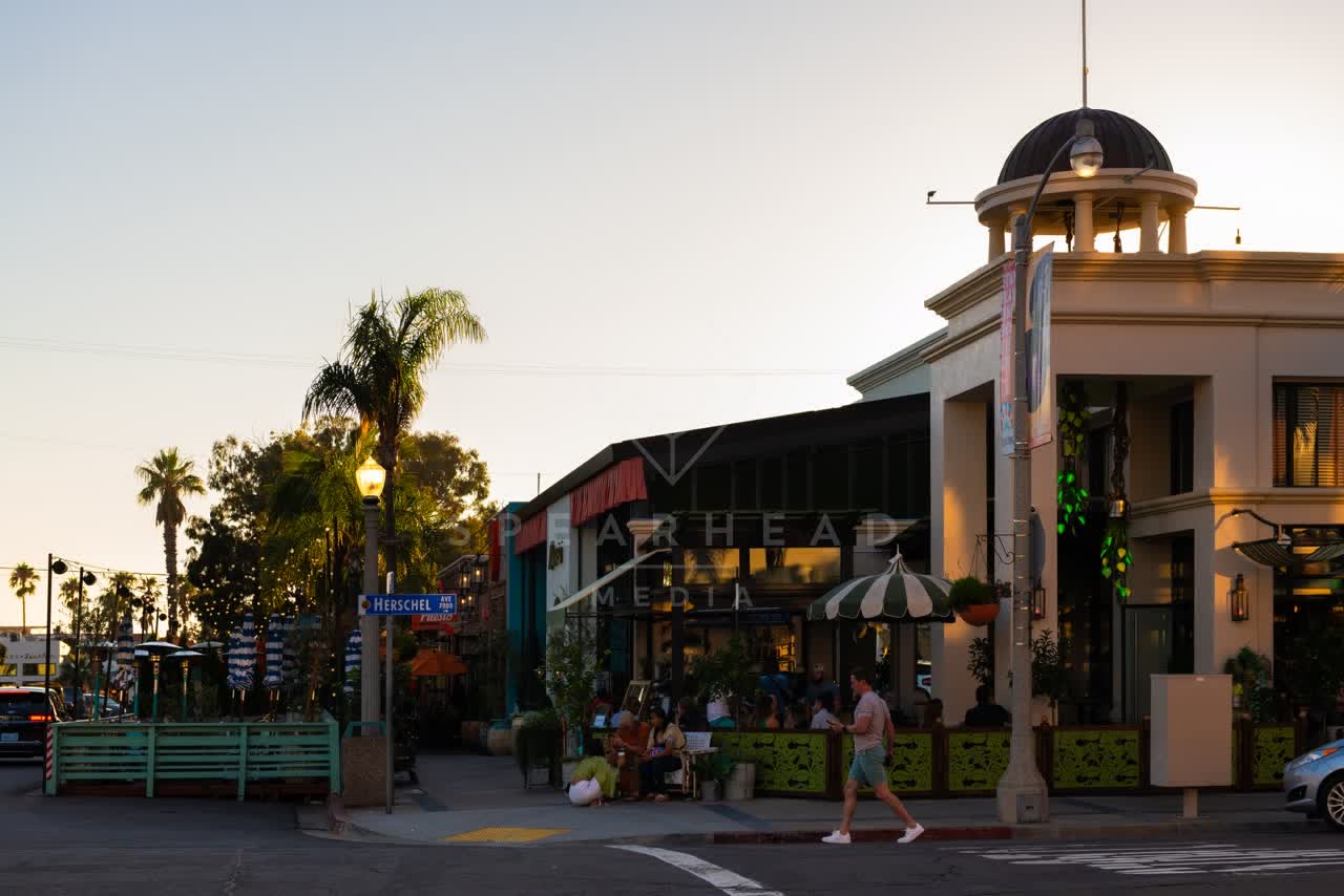 The downtown streets, palm trees and the buildings at Village of La Jolla, with people walking.