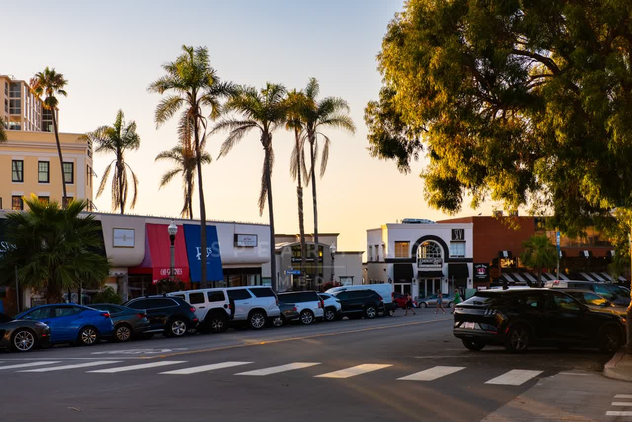 The downtown streets, palm trees and the buildings at Village of La Jolla, with people walking.