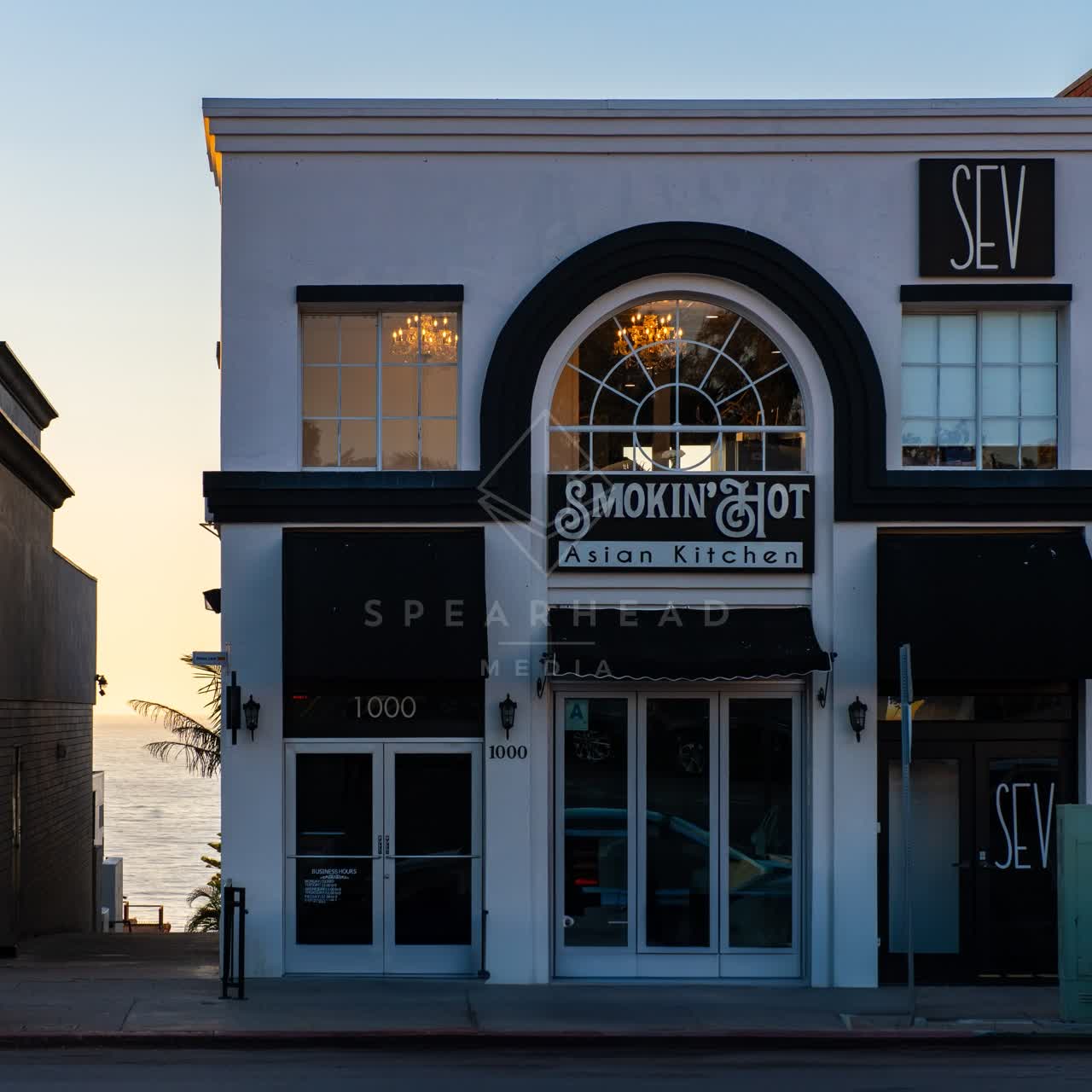 The downtown streets, palm trees and the ocean at Village of La Jolla.