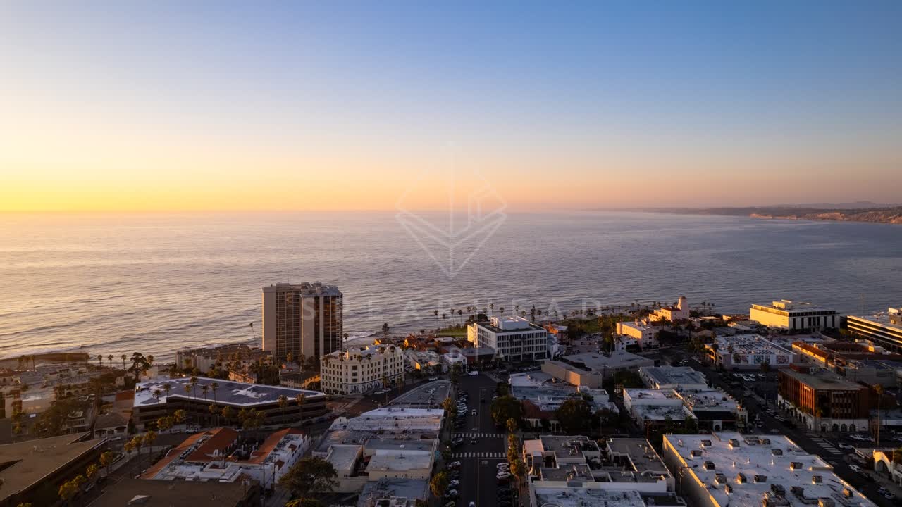 Aerial view of the downtown streets, palm trees and the ocean at La Jolla Cove.