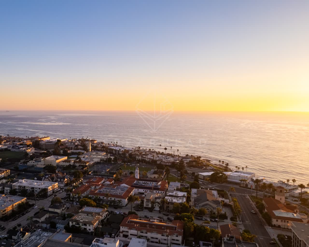 Aerial view of the beach, the skyline and palm trees at La Jolla Cove.