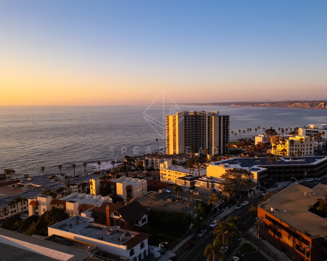 Aerial view of the beach, palm trees and the ocean at La Jolla Cove.