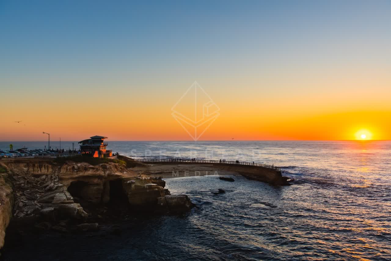 Low aerial view of the cliffs, the ocean and open country at La Jolla Cove.