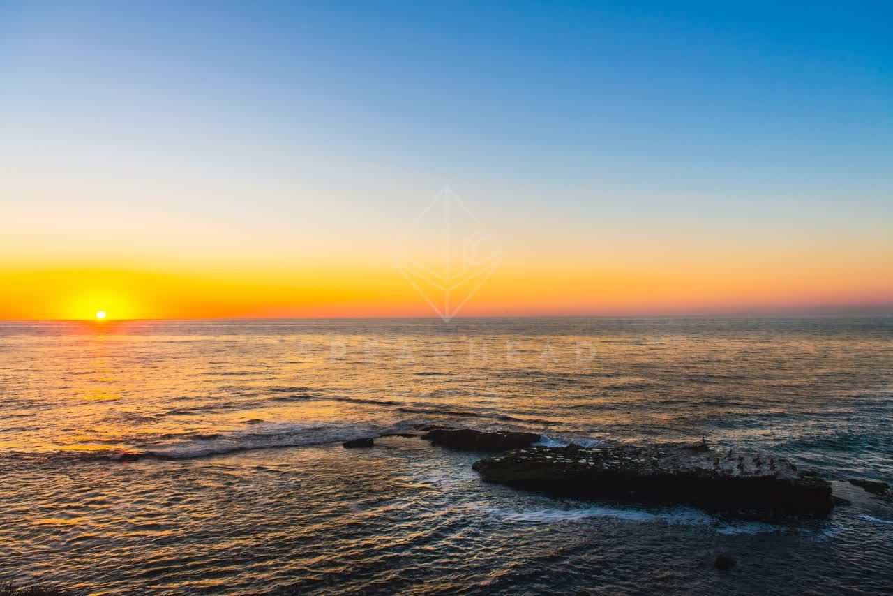 Low aerial view of the cliffs, the ocean and open country at La Jolla Cove.
