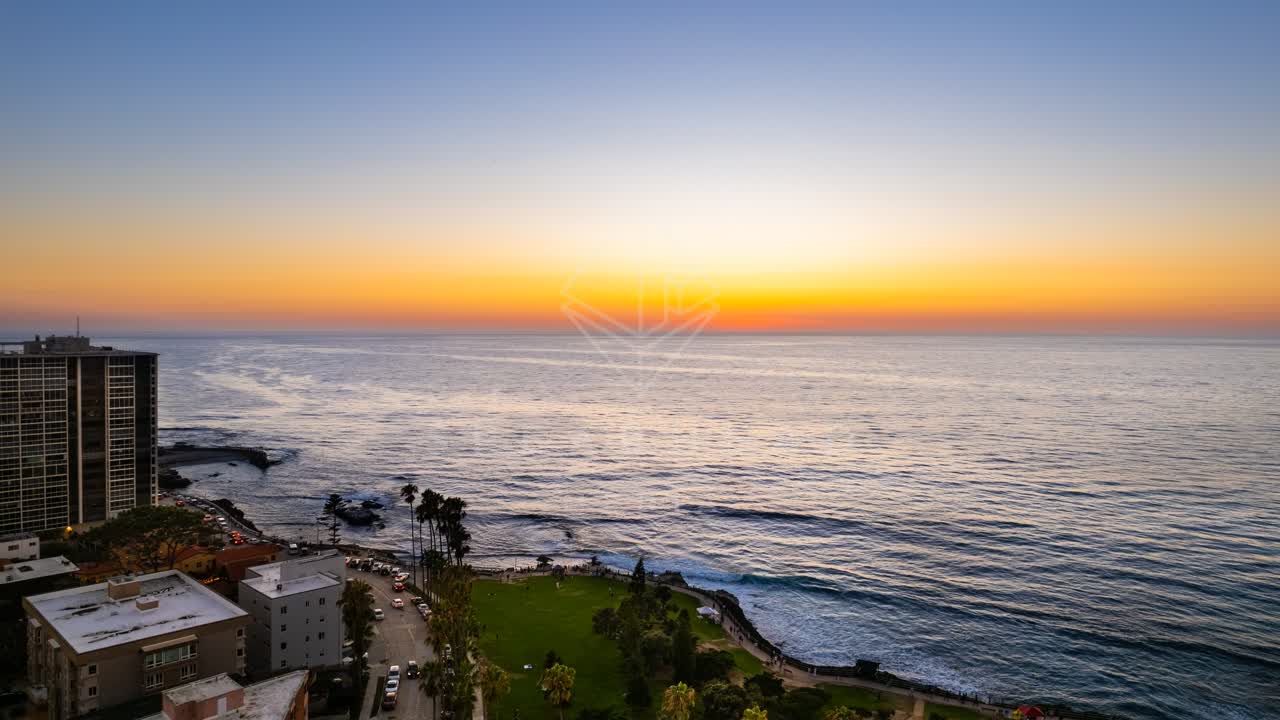 Aerial view of the beach, palm trees and the ocean at La Jolla Cove.