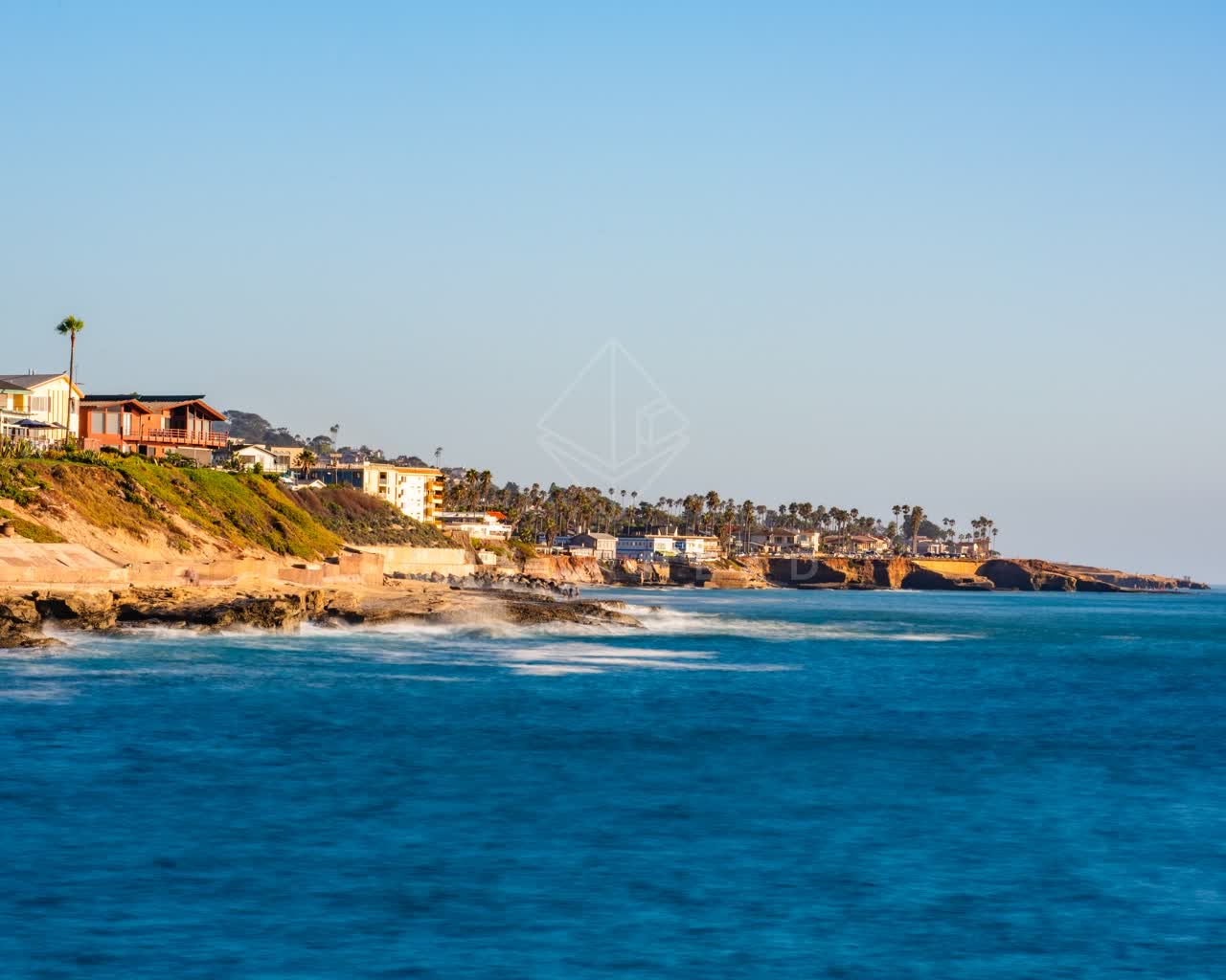 Elevated view of the cliffs, palm trees and the ocean in Ocean Beach.
