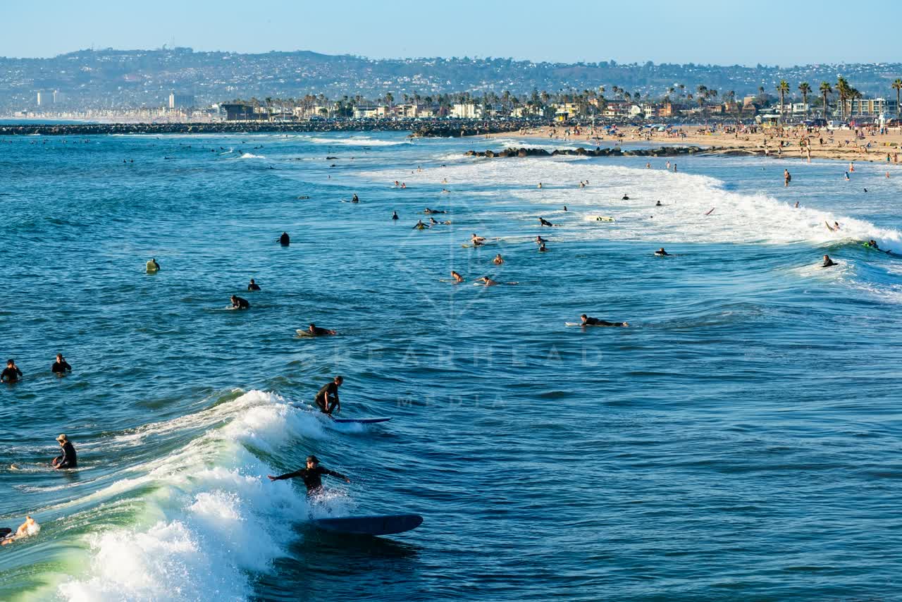 Elevated view of the beach, the surf and the ocean in Ocean Beach, with surfers out.