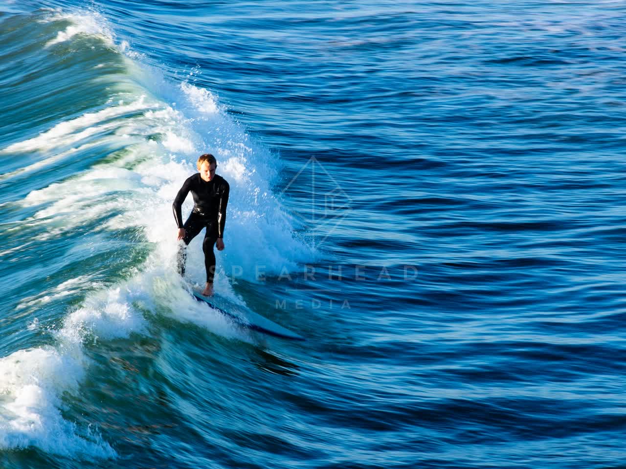 Elevated view of the beach, the surf and the ocean in Ocean Beach, with surfers out.